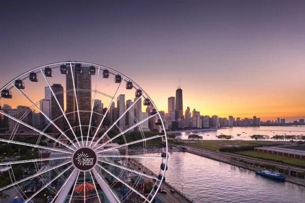 Chicago's Navy Pier at sunset, its iconic ferris wheel in the foreground.